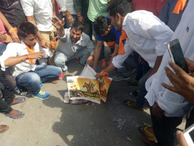 Karni Sena members burn posters