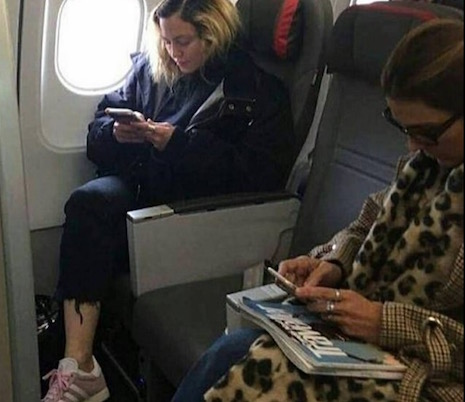 stop the presses! madonna flew in economy class to portugal!