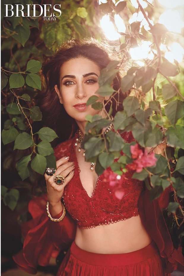  As one of the consistently impeccable sartorial stunners in tinsel town, Karisma Kapoor is always a hoot! While others attempt and falter, Karisma has clearly figured out styles that suit her petite frame with occasional experimentation. Daring silhouettes, unusual fabrics and flattering cuts mark her signature style which she pulls off with an understated aplomb. Describing her own style as classic chic, Karisma Kapoor’s ladylike choices are always a delight. Karisma features as the cover star for this month’s Brides Today edition. Giving us a glimpse of her ethereal charm, Karisma is dressed to nines in some of the stunning creations by designer Ridhi Mehra. Additionally, this edition allows us ample insight with a day in her life – Fitness, Beauty and Diet! The jewellery sported by Karisma is from Rare Heritage, Om Jewellers and TBZ. The photoshoot has been lensed by Prasad Naik at The Great Eastern Home, Byculla in Mumbai and styled by Shaurya Athley. The glam squad features makeup artist Subbu and hairstylist Yianni Tsapatori. Here is a closer look at the cover and the rest of the photoshoot. Cover Star – Karisma Kapoor Karisma flaunts a champagne gold anarkali with a draped dupatta and embellished belt. Statement earrings, a haathphool and ring are the accessories of choice. A subtle makeup of defined eyes, nude lips and wavy half-updo round out her look. Red Alert – Karisma Kapoor Karisma flaunts a bright red creation with black lacy heels, necklace and wavy hair. Karisma wears yet another stunning creation – a lehenga with a pearl necklace and rings. Dreams Galore – Karisma Kapoor Karisma flaunts her curves in this pale coloured creation with an opulent necklace, minimal makeup and wind kissed hair. Pretty Pastels – Karisma Kapoor Karisma wears a pretty pink creation with jewellery, subtle makeup and wavy hair. Print on Print – Karisma Kapoor Karisma wears a printed creation with statement-making earrings, subtle makeup and wavy hair. Well, if you are looking to having a flawless complexion and frame just like Karisma, this edition of Brides Today cover should be your go-to guide this month!