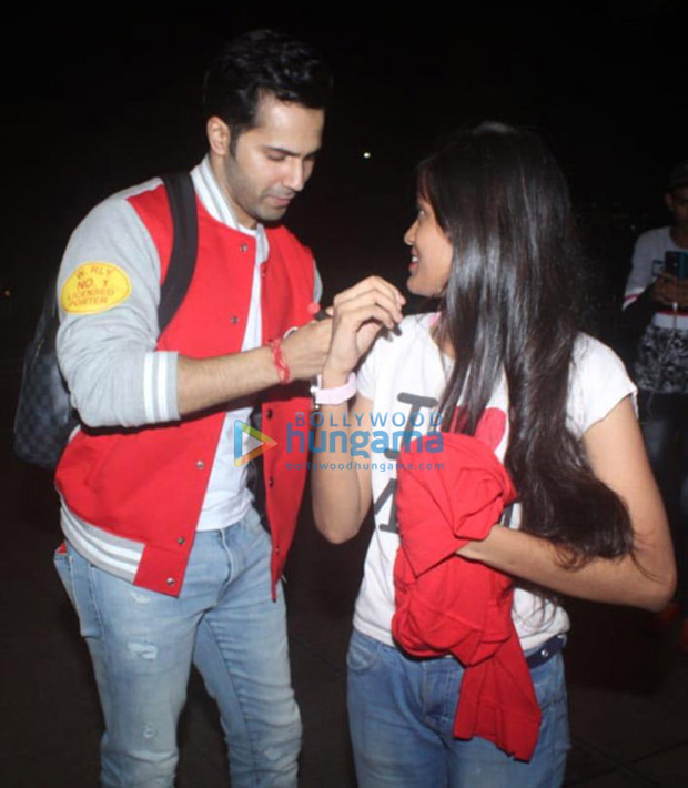 varun dhawan bumps into his fan at the airport; makes her day by giving an autograph on her t-shirt