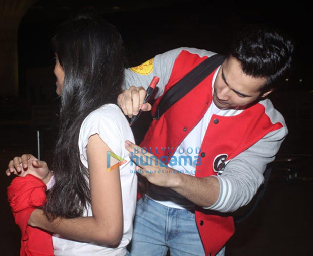 varun dhawan bumps into his fan at the airport; makes her day by giving an autograph on her t-shirt