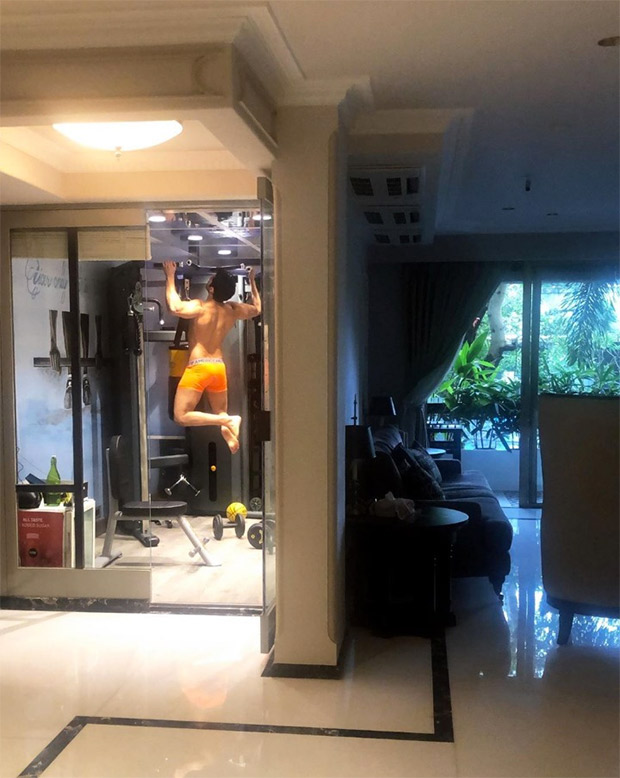 Varun Dhawan working out SHIRTLESS in just his orange trunks is going to make the melancholic weather better for you