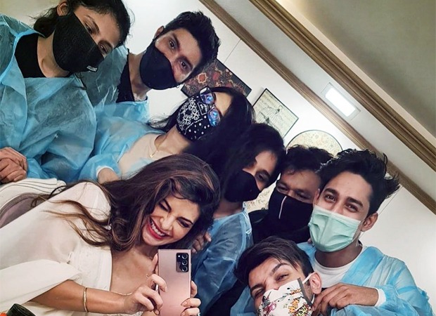 Jacqueline Fernandez poses with her team as she resumes work