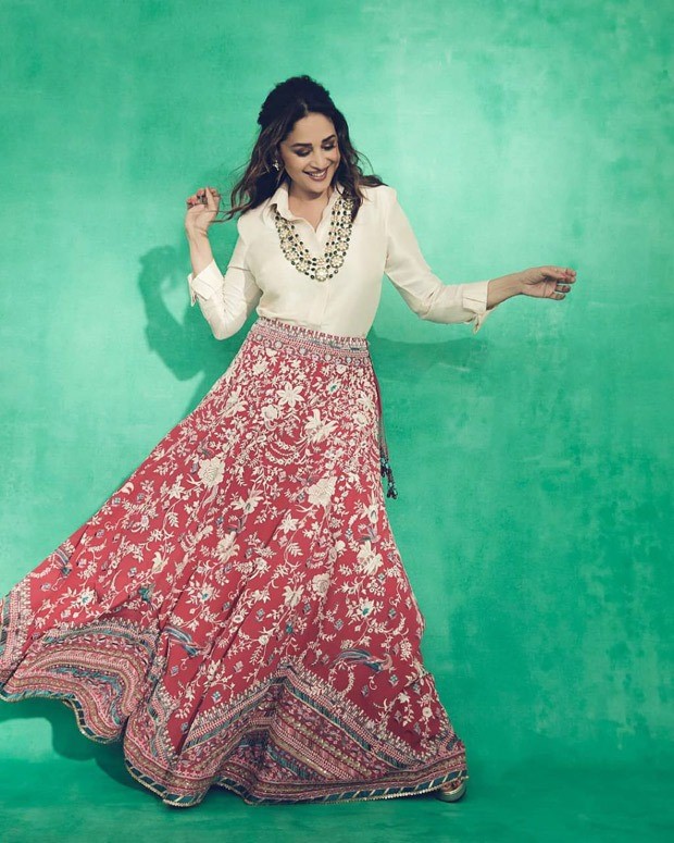 Madhuri Dixit gives modern contemporary feels by pairing a satin shirt with red lehenga skirt