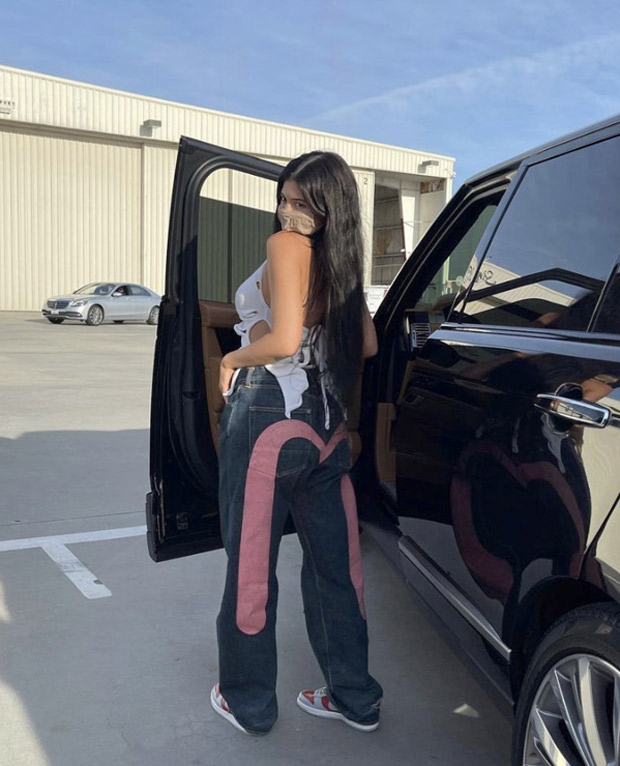 kylie jenner pairs plunging neckline crop top with printed wide leg pants