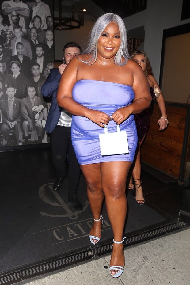 lizzo pairs her lilac bodycon mini dress with silver wig and ‘protect black people’ mini box bag