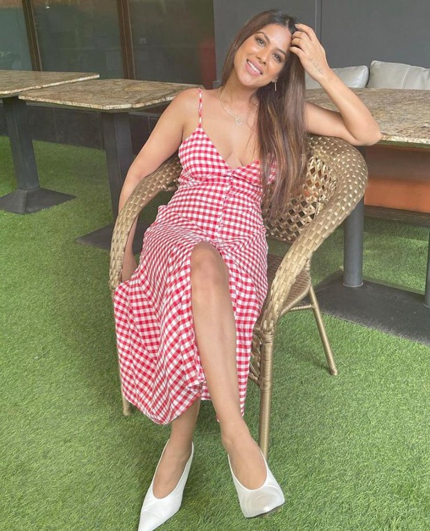 nia sharma opts for summer’s breakout checkered print trend; dons plunging neckline and thigh-high slit maxi dress