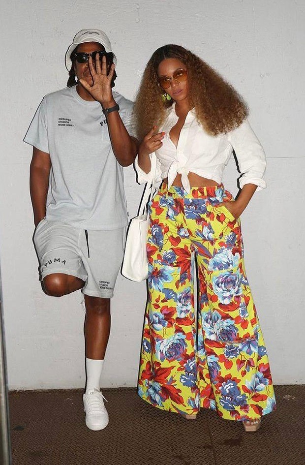 beyoncé pairs christopher john rogers floral yellow wide-legged trousers with white shirt as she heads for lunch date with jay z