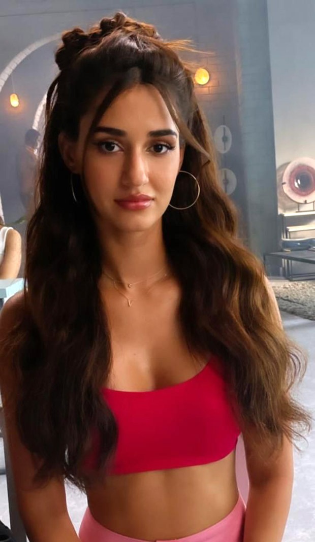 Disha Patani looks ravishing in a bubble gum pink utility pants and red crop top with a funky hair do