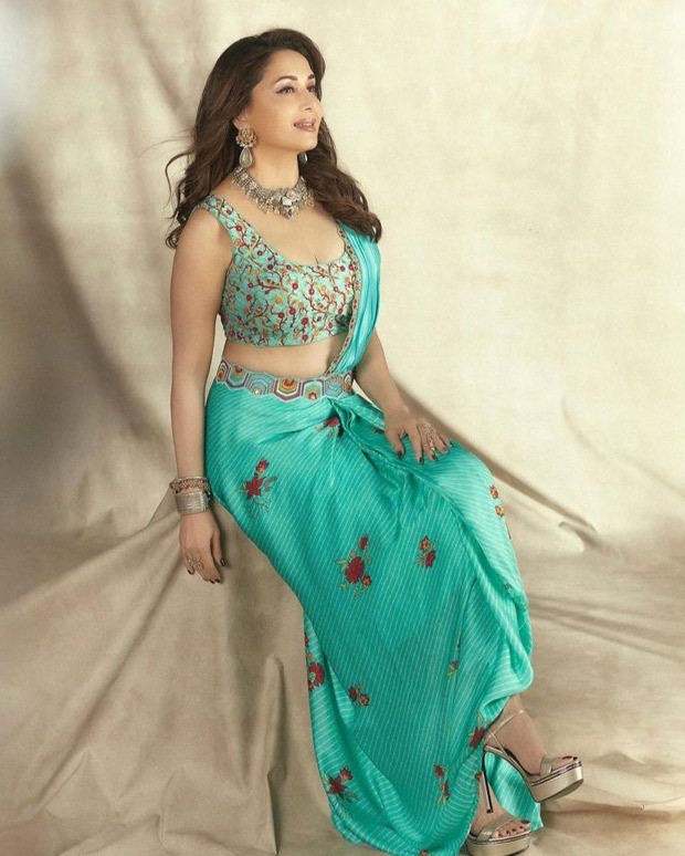 Madhuri Dixit looks gorgeous in a Turquoise pre-draped saree from Punit Balana worth Rs.35,500