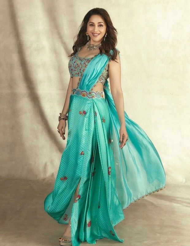 Madhuri Dixit looks gorgeous in a Turquoise pre-draped saree from Punit Balana worth Rs.35,500