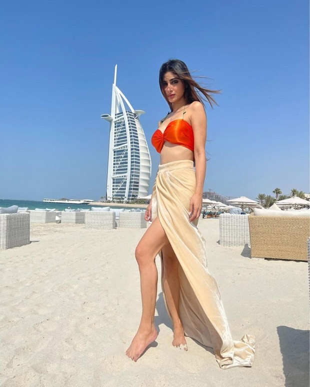 Mouni Roy pairs a neon orange bikini top with thigh-high slit skirt in Dubai