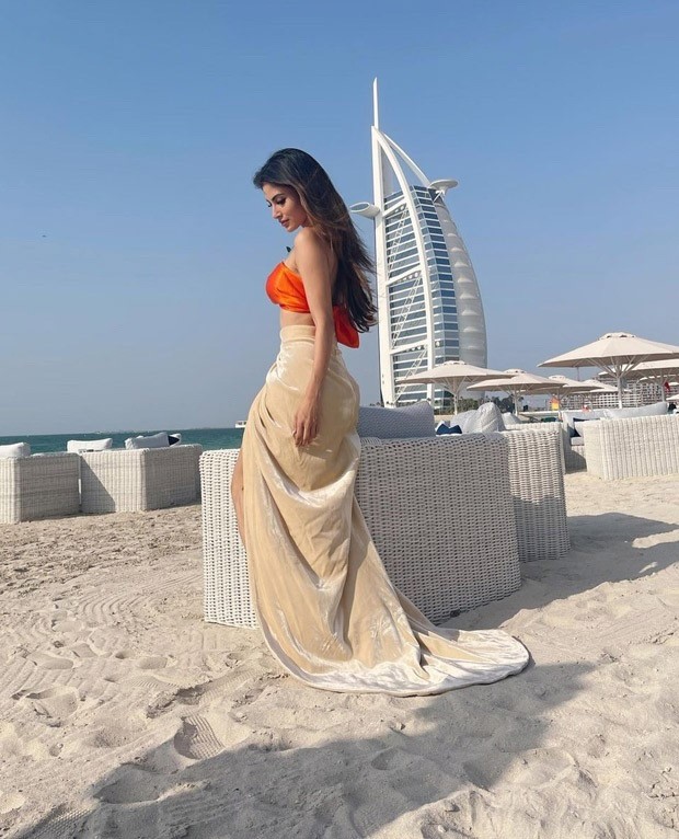 Mouni Roy pairs a neon orange bikini top with thigh-high slit skirt in Dubai