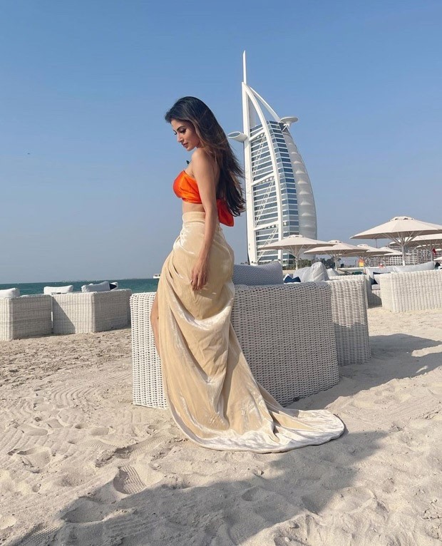 Mouni Roy pairs a neon orange bikini top with thigh-high slit skirt in Dubai